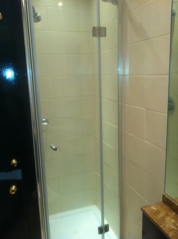 Frameless glass shower enclosure with chrome fittings in Luton
